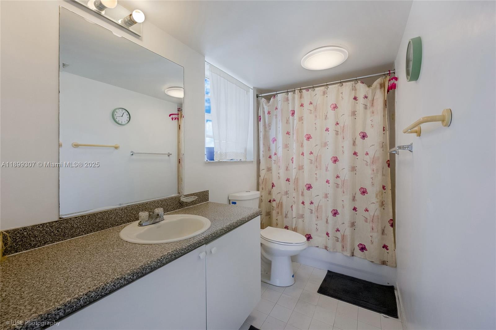 8900 Collins Avenue, Unit 301 Surfside, FL 33154 - Photo 9 of 35 a bathroom with a sink toilet a shower and a mirror