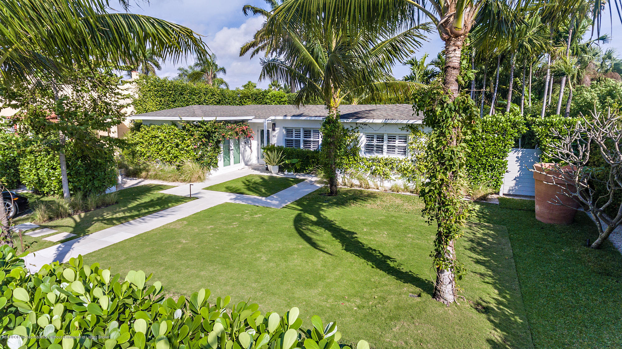 321 Churchill Road West Palm Beach, FL 33405 - Photo 1 of 44 a view of a garden with a building in the background