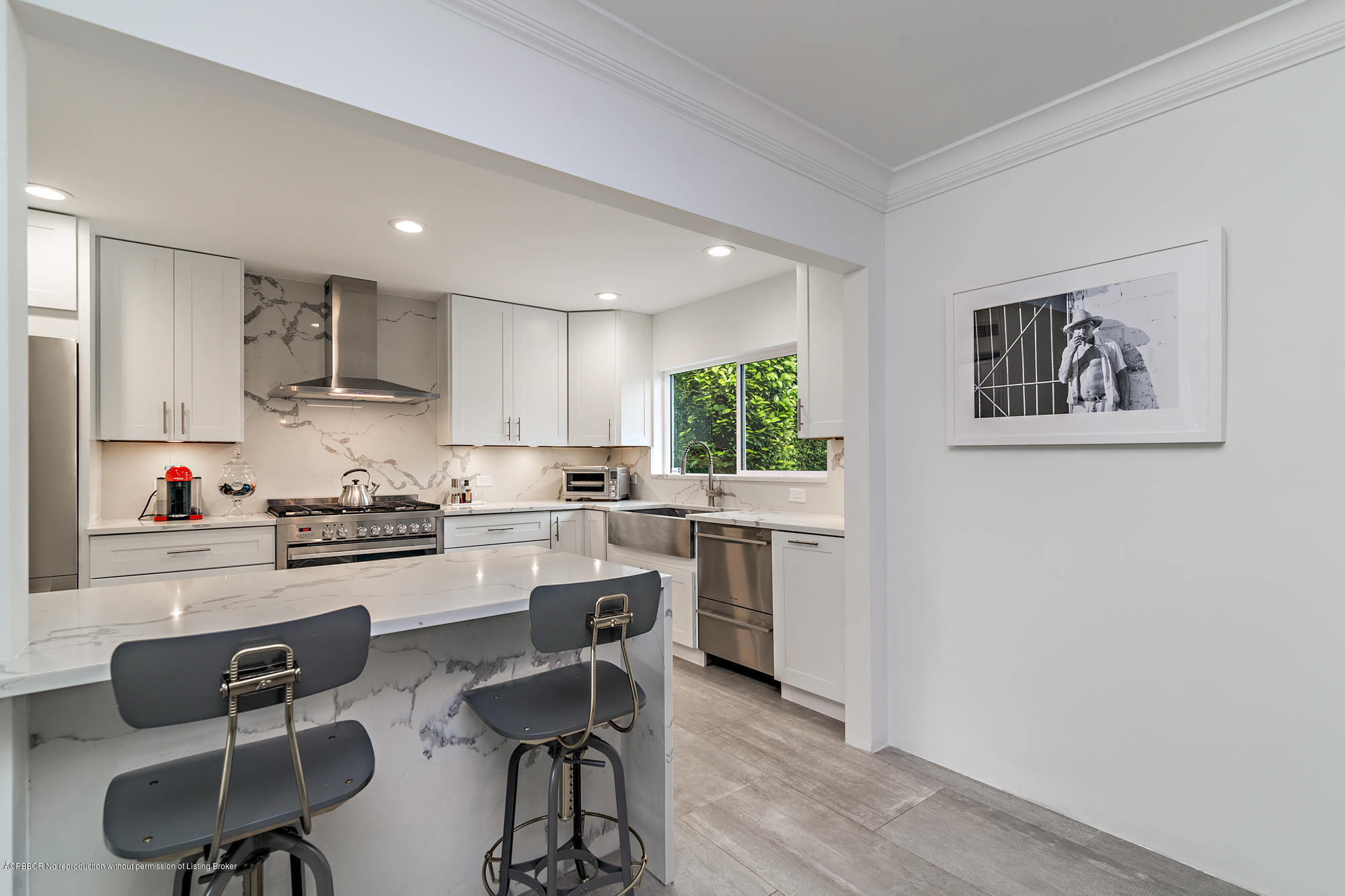 321 Churchill Road West Palm Beach, FL 33405 - Photo 11 of 44 a kitchen with white cabinets and chairs