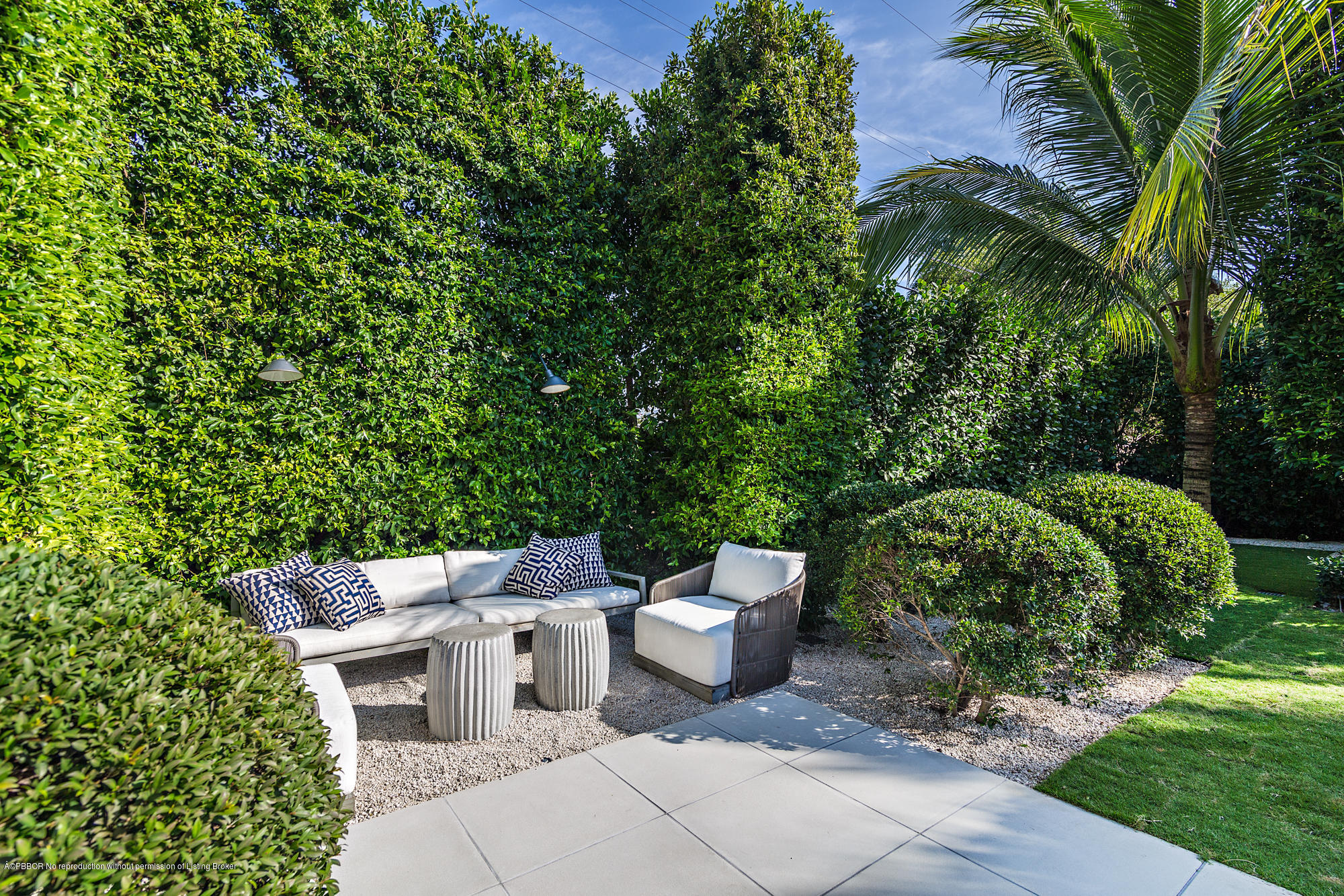 321 Churchill Road West Palm Beach, FL 33405 - Photo 24 of 44 a view of a patio with table and chairs potted plants and large tree