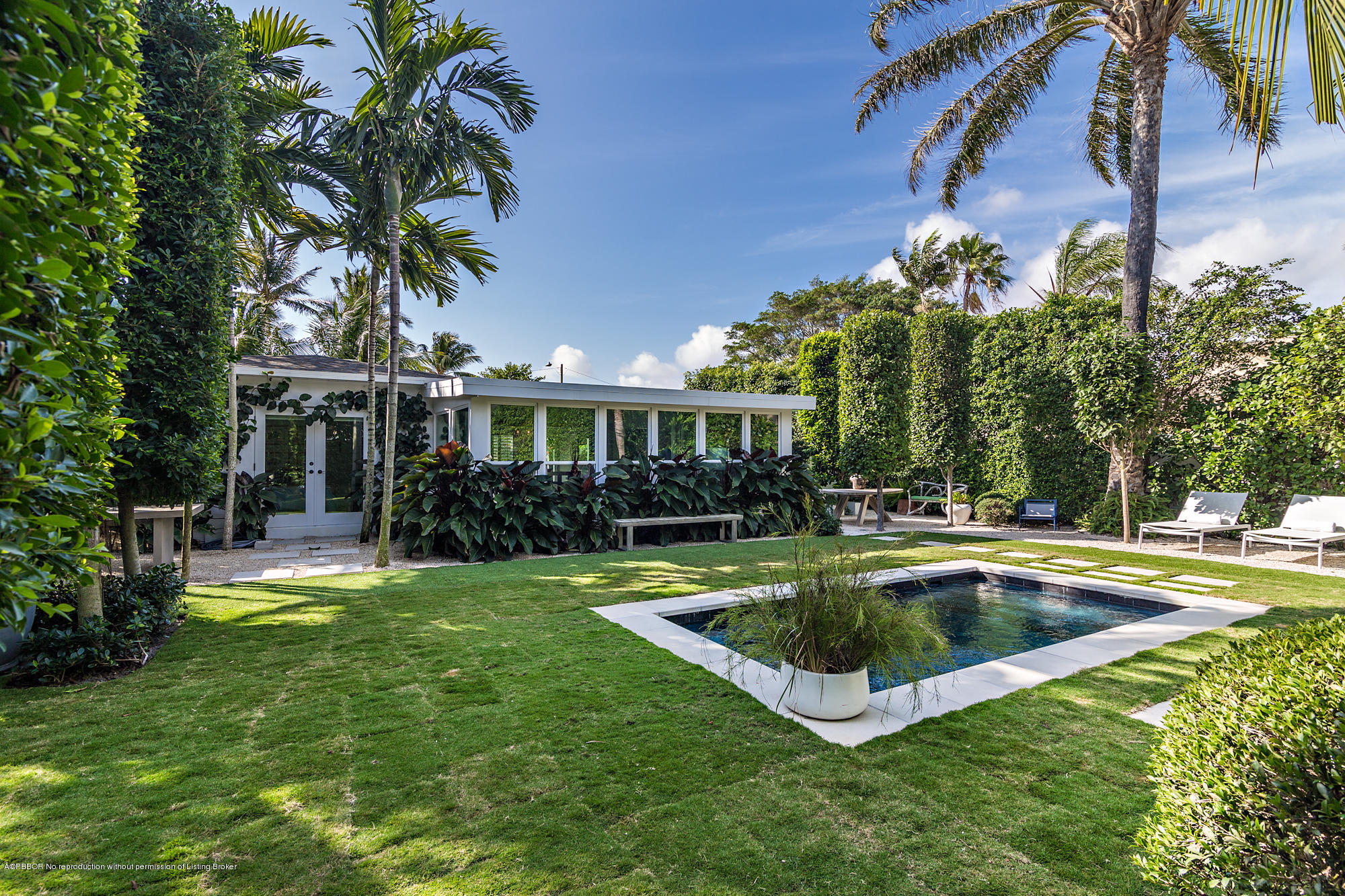 321 Churchill Road West Palm Beach, FL 33405 - Photo 35 of 44 a view of swimming pool with lawn chairs and plants
