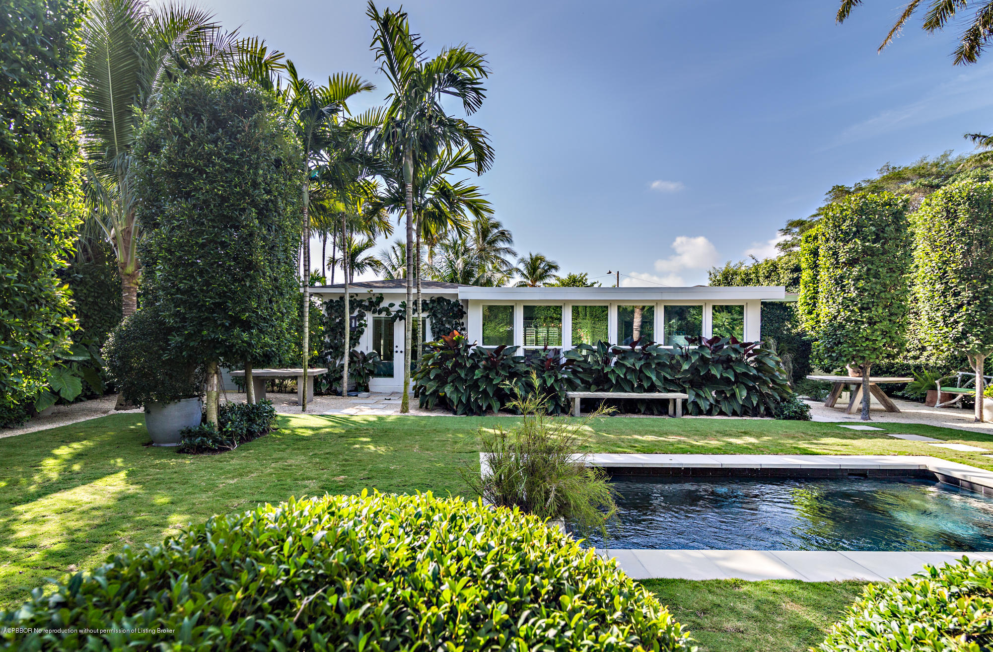 321 Churchill Road West Palm Beach, FL 33405 - Photo 36 of 44 a view of a house with swimming pool and a garden