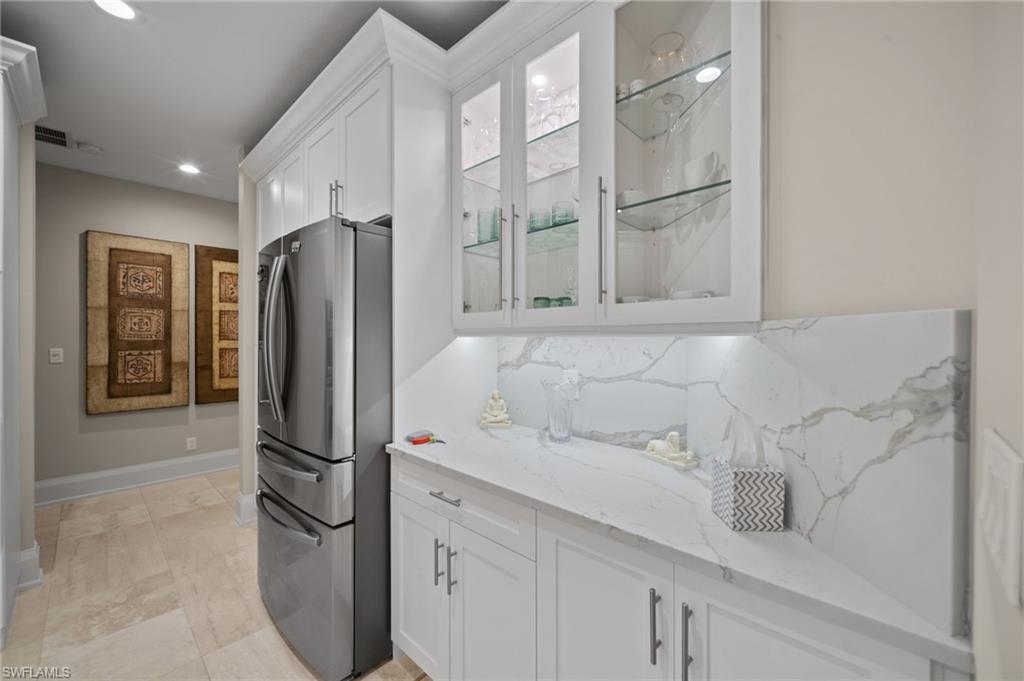 261 Colonade Circle, Unit 2701 Naples, FL 34103 - Photo 12 of 49 a kitchen with stainless steel appliances refrigerator and cabinets