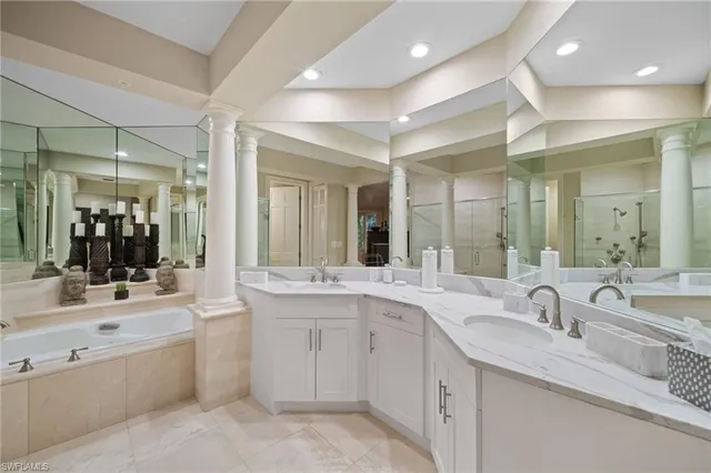 a large bathroom with a double vanity sink and mirror with shower