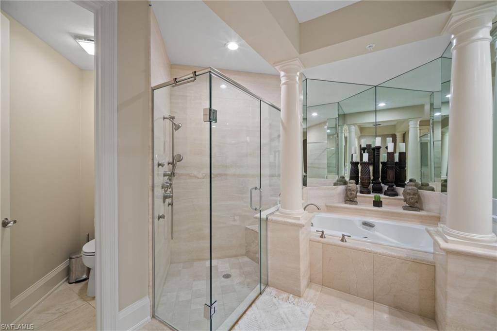 261 Colonade Circle, Unit 2701 Naples, FL 34103 - Photo 22 of 49 a bathroom with a shower sink and mirror