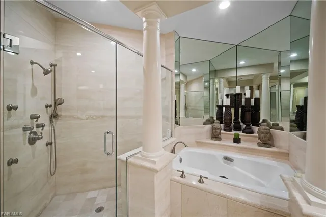 a bathroom with a sink mirror and shower