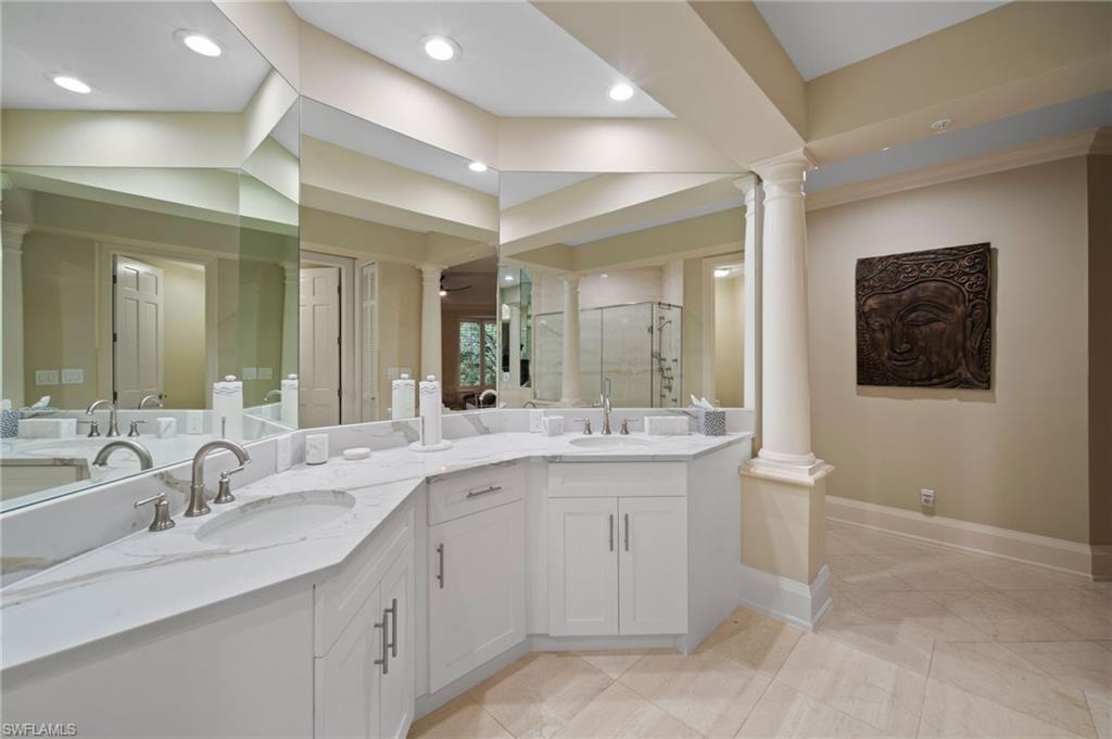 261 Colonade Circle, Unit 2701 Naples, FL 34103 - Photo 24 of 49 a bathroom with a granite countertop sink and a mirror
