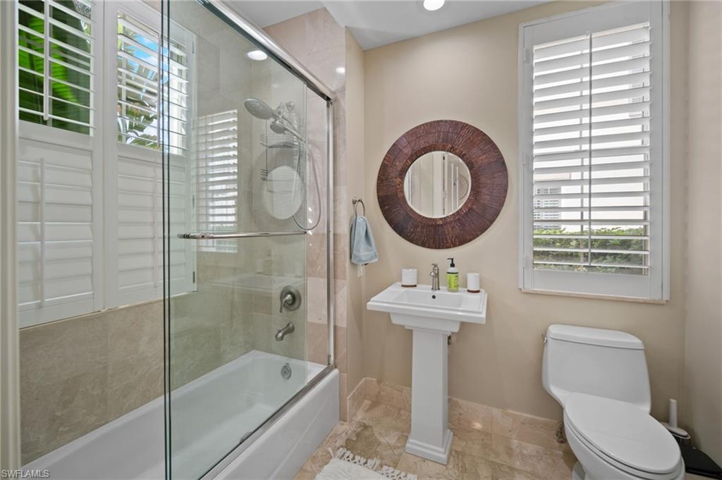 261 Colonade Circle, Unit 2701 Naples, FL 34103 - Photo 28 of 49 a bathroom with a sink a toilet and shower