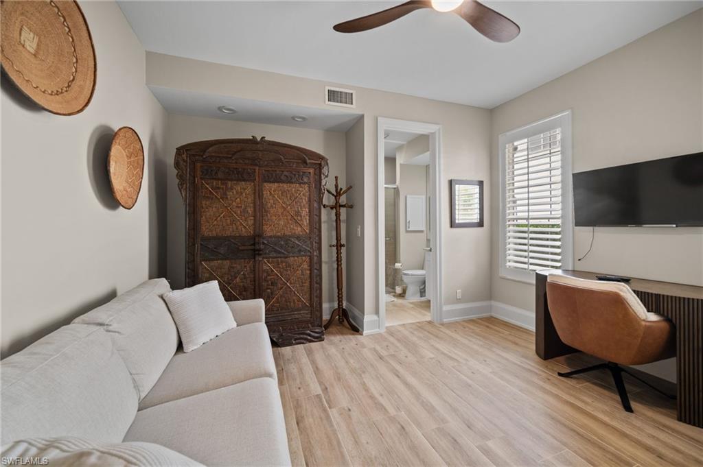 261 Colonade Circle, Unit 2701 Naples, FL 34103 - Photo 31 of 49 a living room with furniture and a flat screen tv