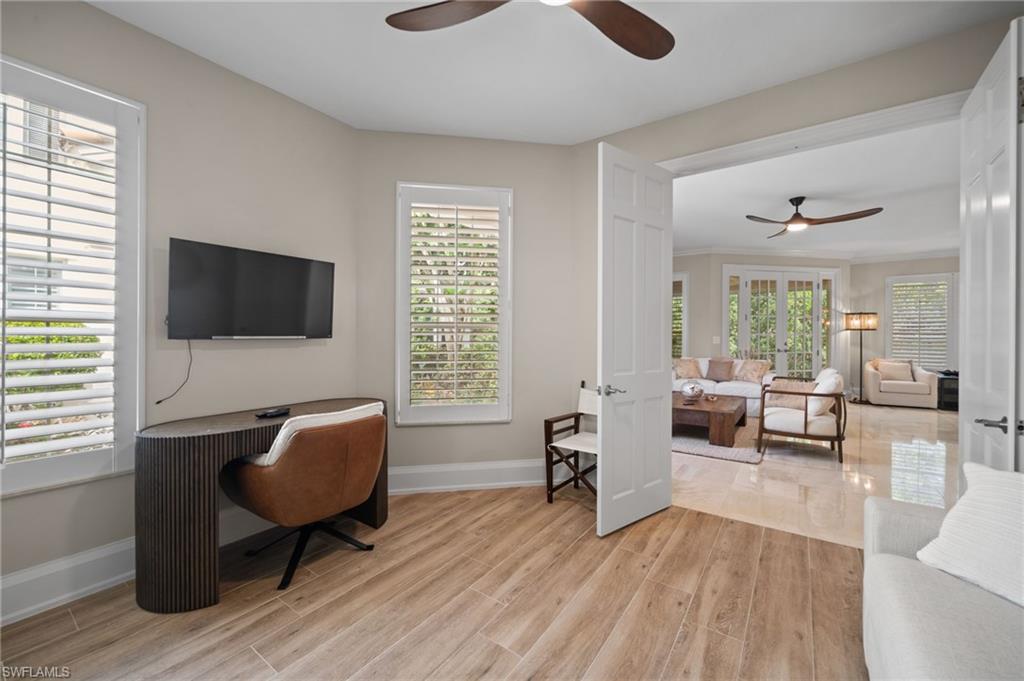 261 Colonade Circle, Unit 2701 Naples, FL 34103 - Photo 32 of 49 a living room with furniture and a flat screen tv