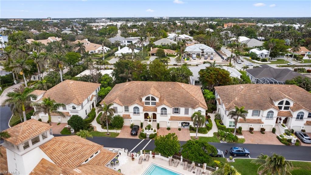261 Colonade Circle, Unit 2701 Naples, FL 34103 - Photo 40 of 49 an aerial view of multiple houses with yard