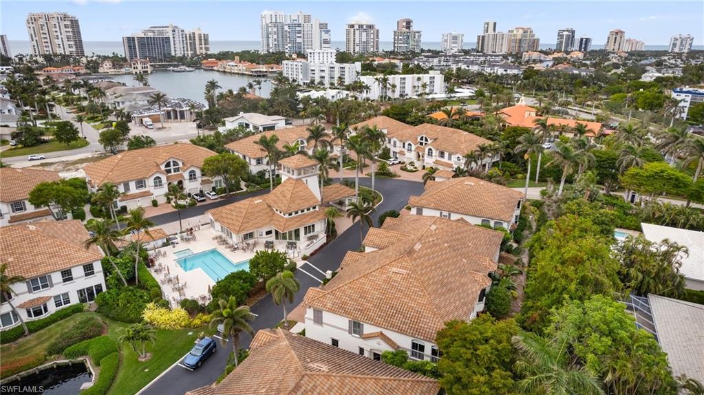 261 Colonade Circle, Unit 2701 Naples, FL 34103 - Photo 42 of 49 an aerial view of city and lake