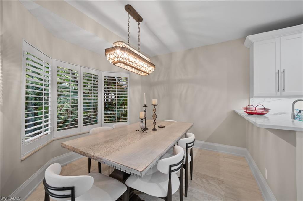 261 Colonade Circle, Unit 2701 Naples, FL 34103 - Photo 8 of 49 a view of a dining room with furniture window and outside view