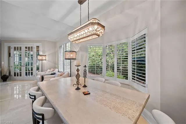 a view of a dining room with furniture wooden floor and chandelier