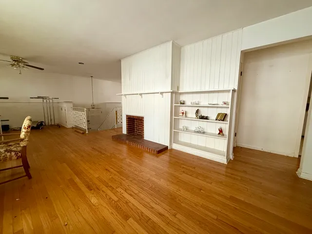 a view of a room with wooden floor