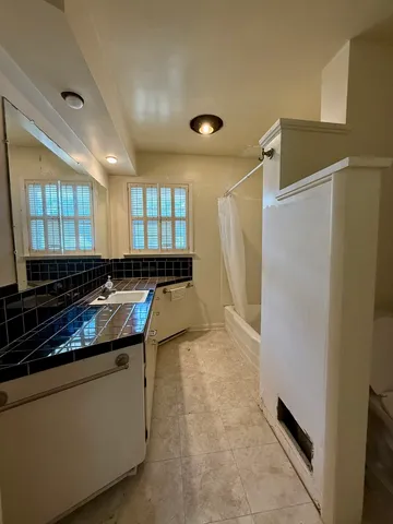 a kitchen with a refrigerator and a sink
