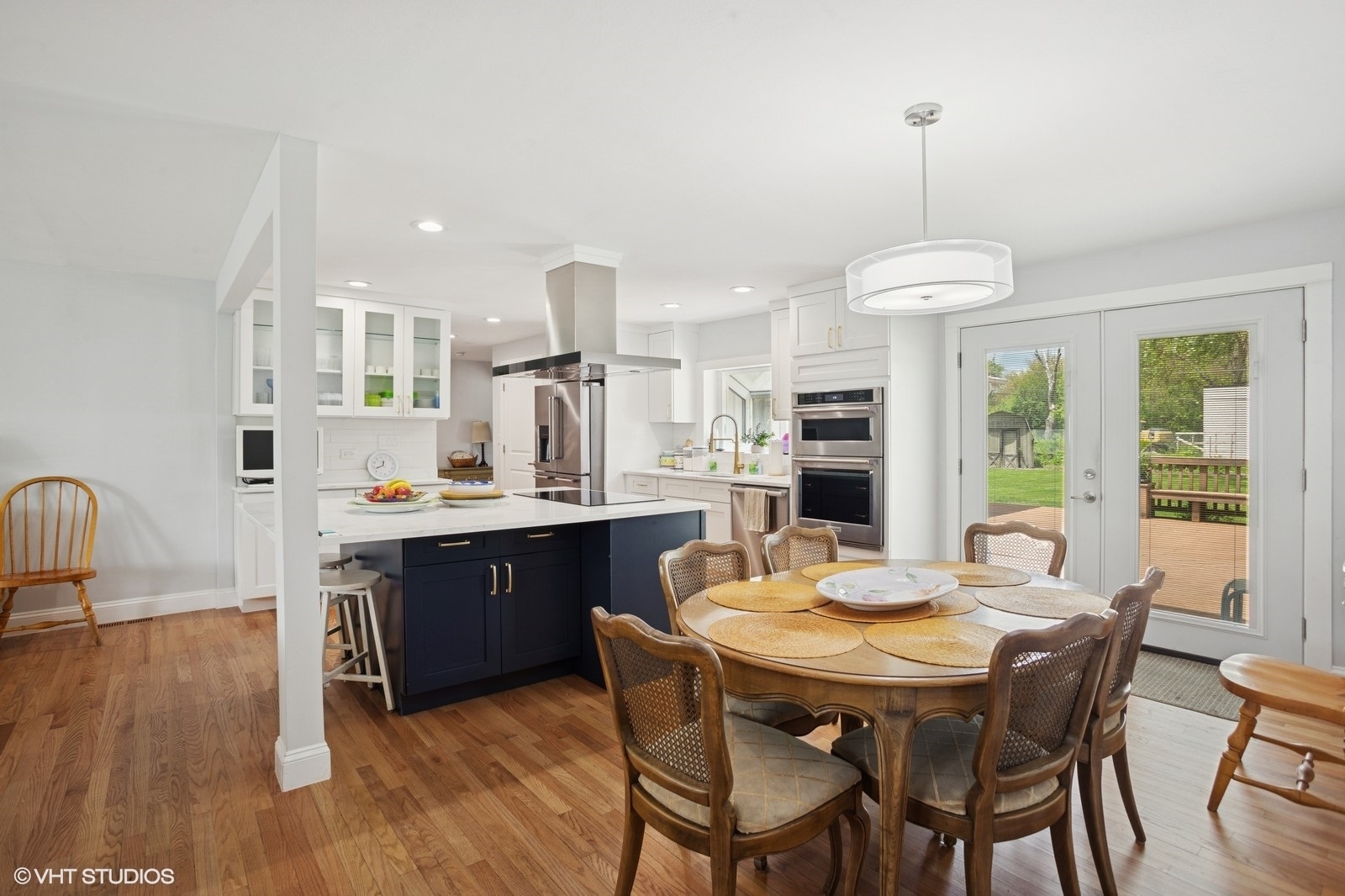 2050 Beechnut Road Northbrook, IL 60062 - Photo 5 of 18 a view of a dining room and livingroom with furniture wooden floor a chandelier