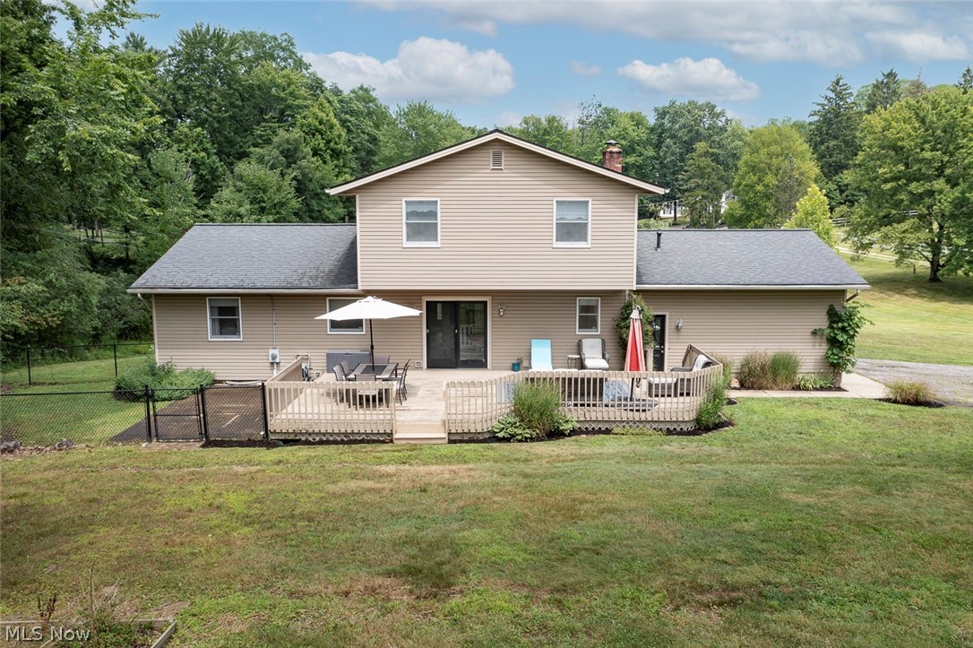 3090 Sourek Road Akron, OH 44333 - Photo 35 of 36 Rear exterior featuring a multi-level wood deck with spindle railings, sliding glass door access, and a concrete patio section