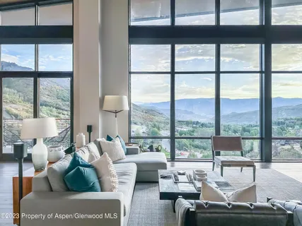 a living room with furniture and a floor to ceiling window