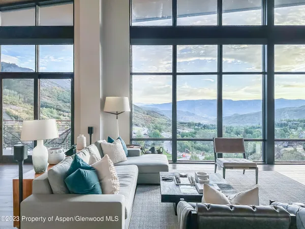 a living room with furniture and a floor to ceiling window