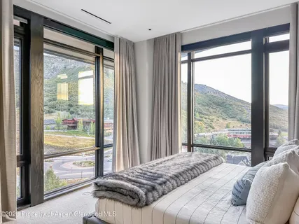 a bedroom with a bed and glass window