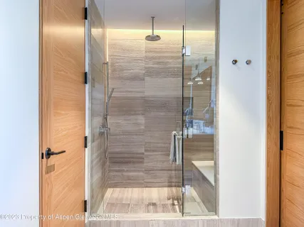 a bathroom with a glass shower door