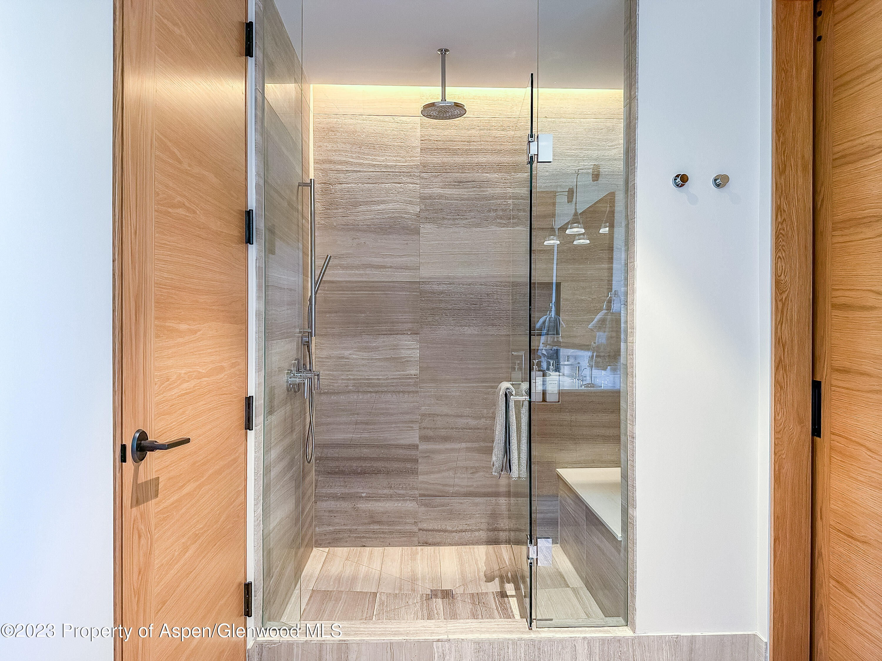 77 Wood Road, Unit 607E Snowmass Village, CO 81615 - Photo 15 of 29 a bathroom with a glass shower door