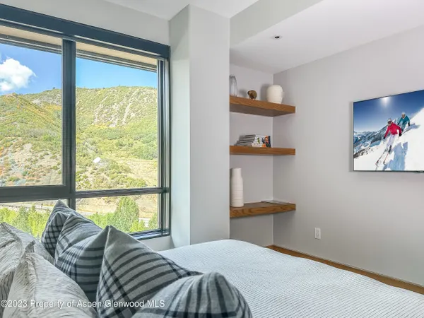 a bedroom with a bed and a large window