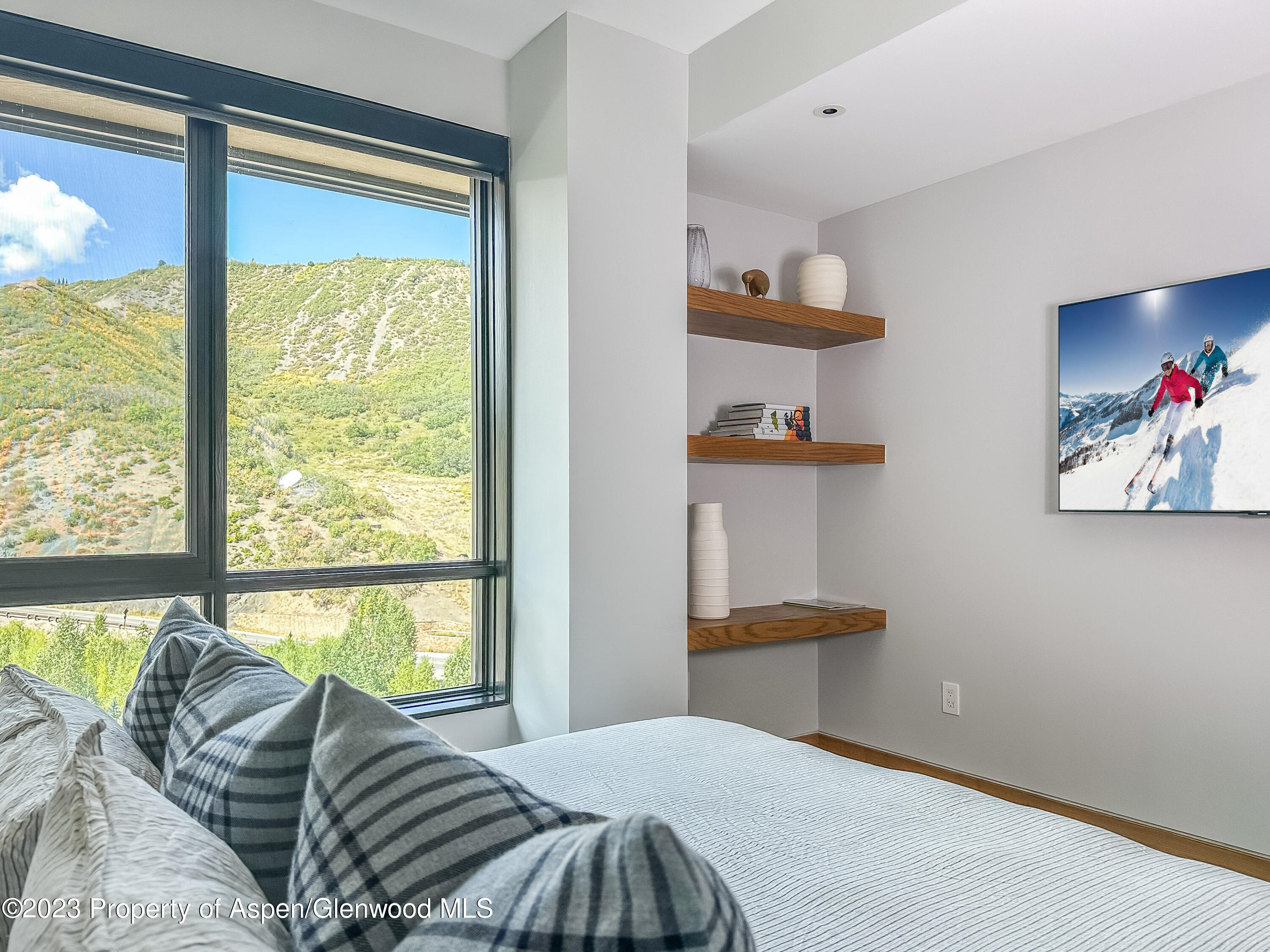 77 Wood Road, Unit 607E Snowmass Village, CO 81615 - Photo 17 of 29 a bedroom with a bed and a large window