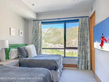 a bedroom with a bed and a large window