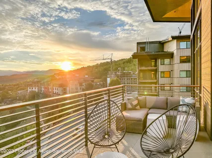 a view of a balcony with furniture