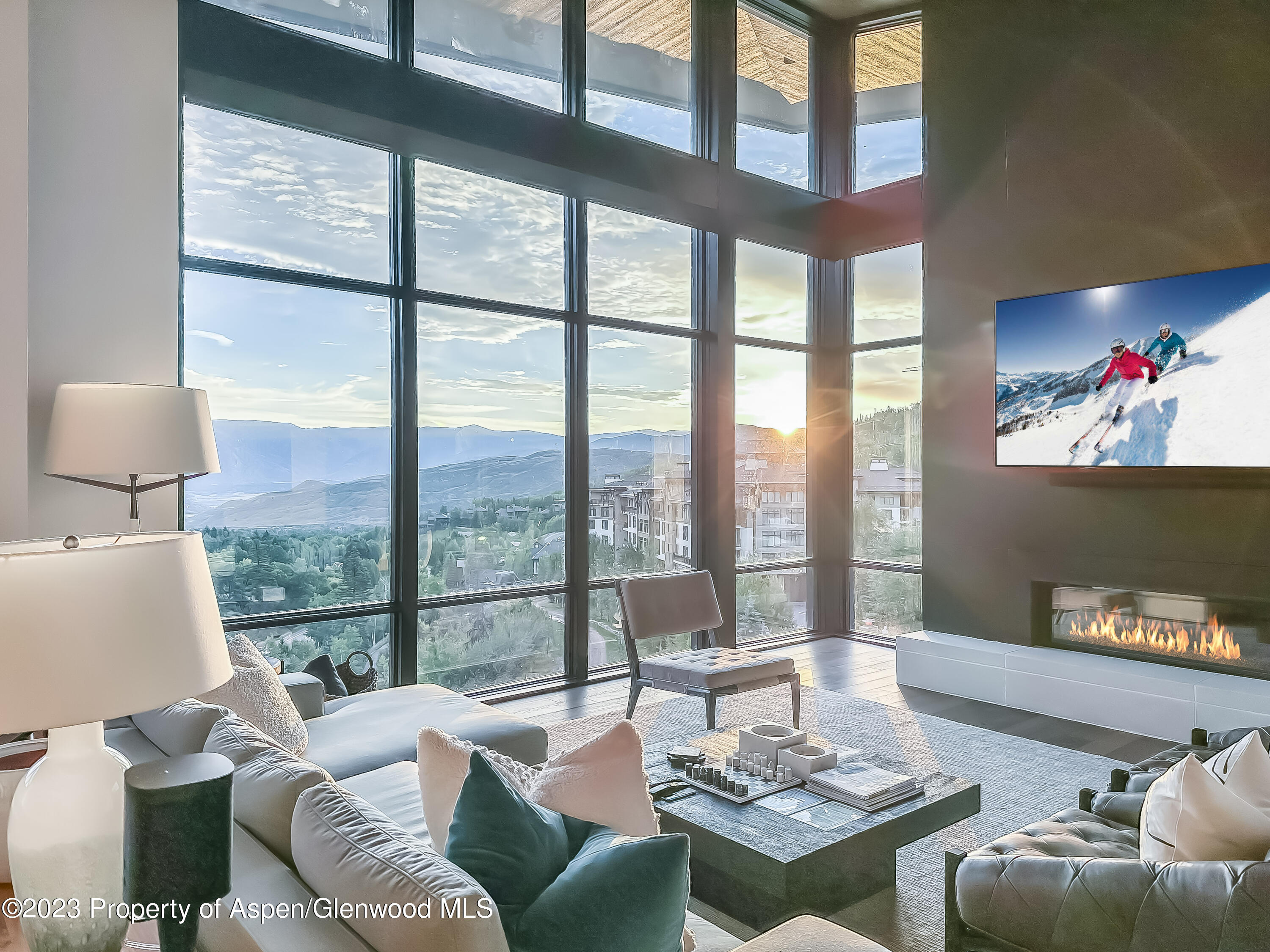 77 Wood Road, Unit 607E Snowmass Village, CO 81615 - Photo 3 of 29 a living room with furniture and a floor to ceiling window