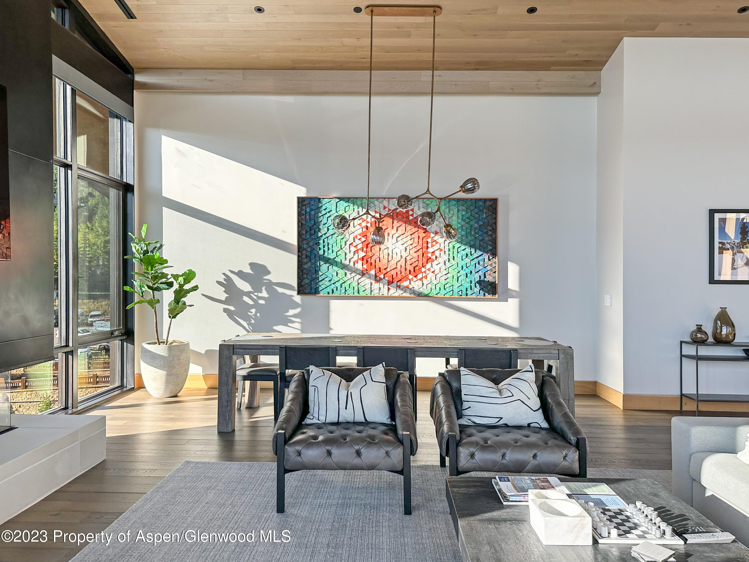 77 Wood Road, Unit 607E Snowmass Village, CO 81615 - Photo 5 of 29 a view of a dining room with furniture one side kitchen view and wooden floor