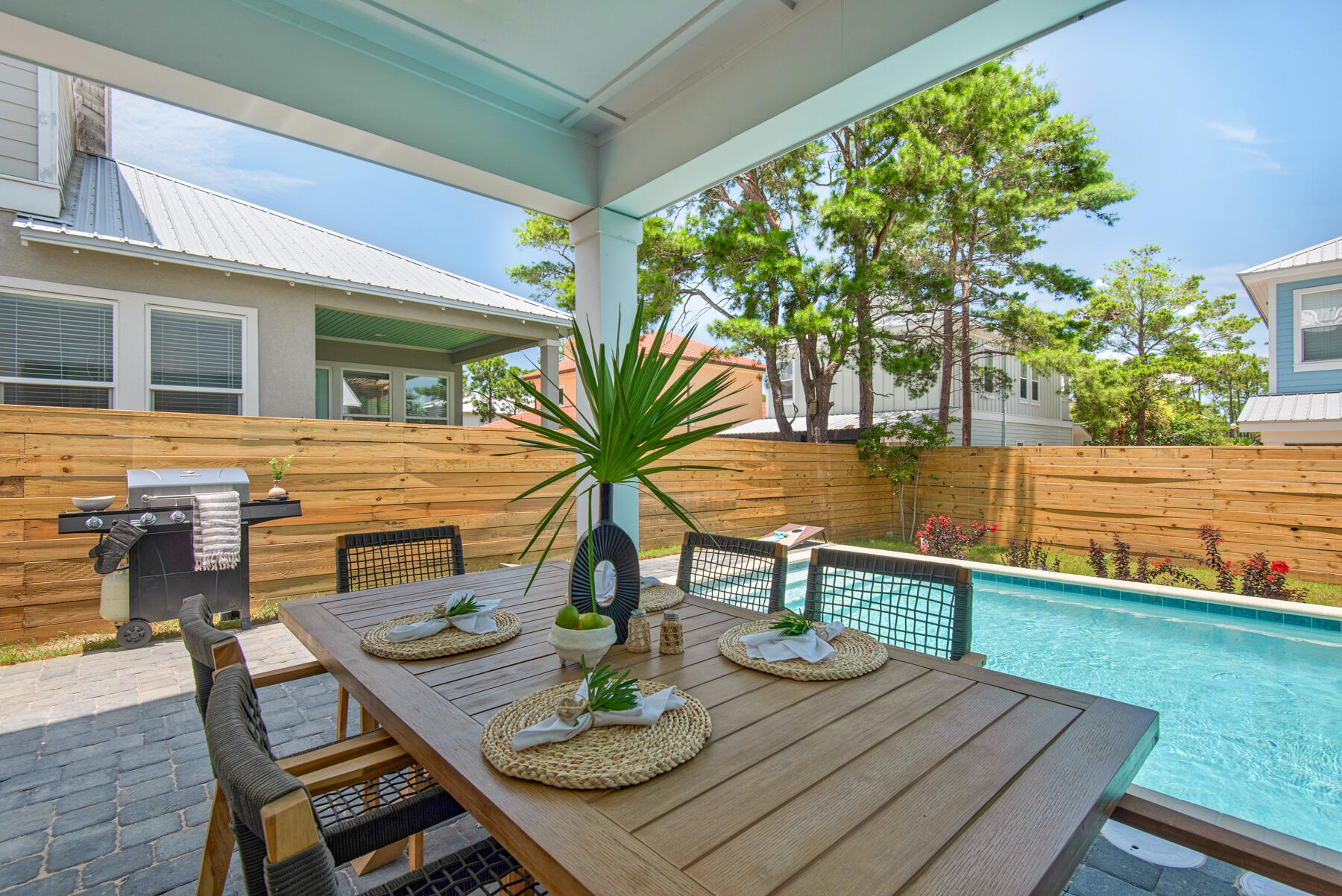 22 Ruth Street Miramar Beach, FL 32550 - Photo 11 of 66 a view of a patio with table and chairs and potted plants