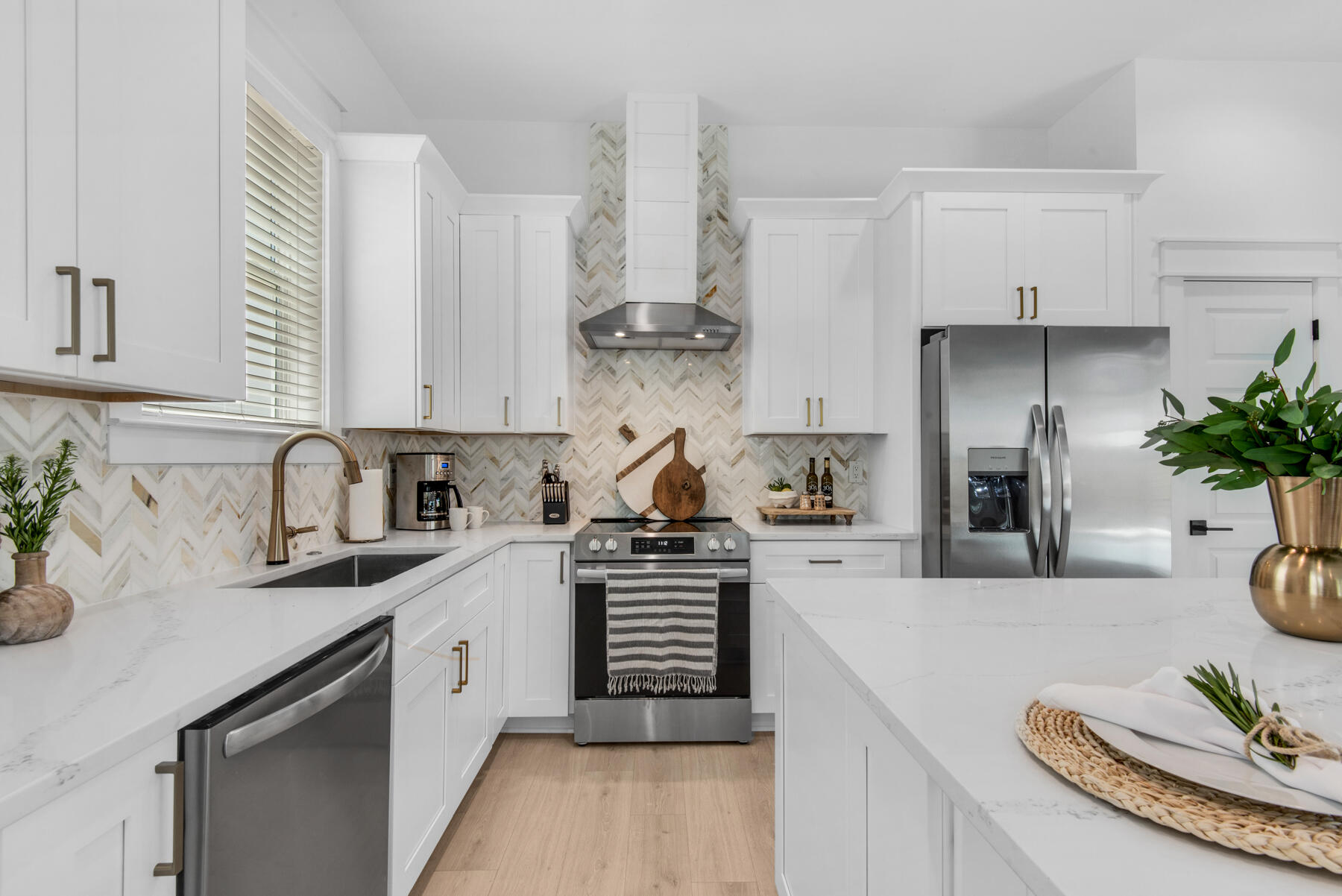 22 Ruth Street Miramar Beach, FL 32550 - Photo 18 of 66 a kitchen with stainless steel appliances a sink a stove a chimney a refrigerator and cabinets