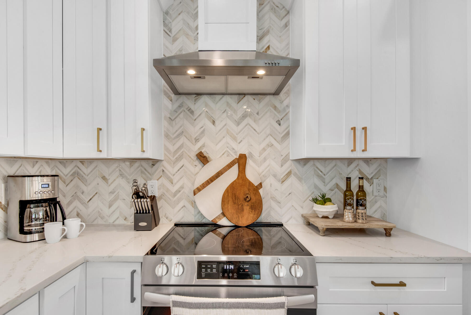 22 Ruth Street Miramar Beach, FL 32550 - Photo 20 of 66 a kitchen with a stove and cabinets