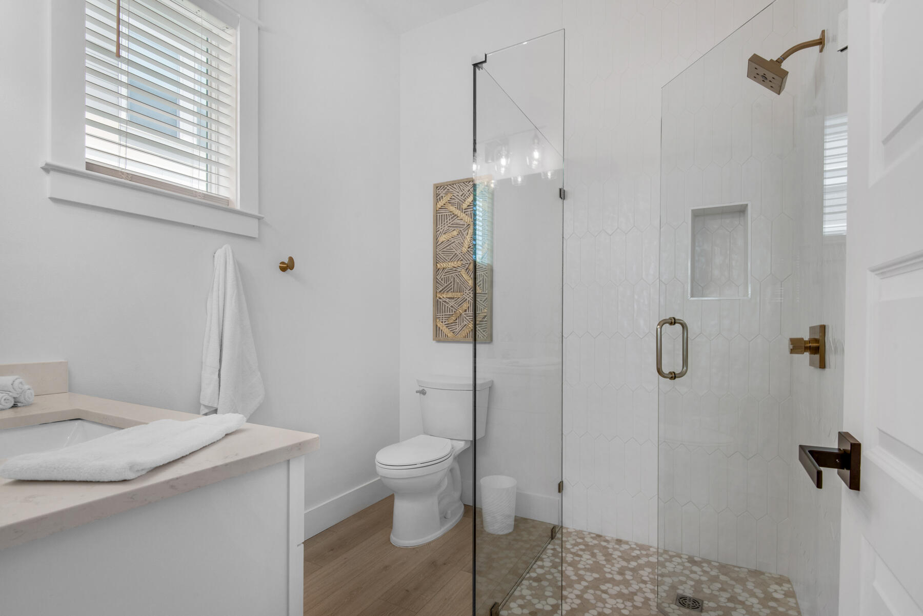 22 Ruth Street Miramar Beach, FL 32550 - Photo 32 of 66 a bathroom with a granite countertop sink a toilet a shower and a window