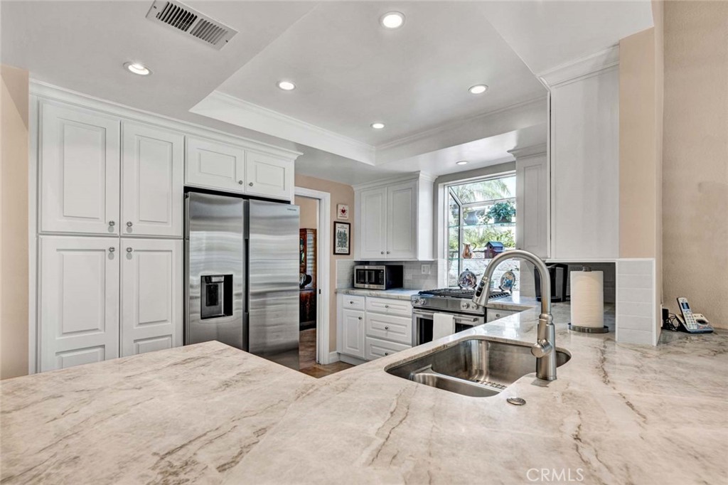 7710 East Strawberry Ridge Orange, CA 92869 - Photo 14 of 33 Quartzite countertop. The stove/cooktop have a built-in downdraft exhaust fan.