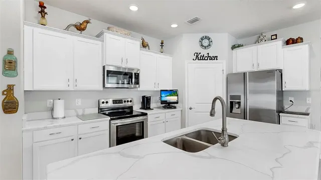 a kitchen with refrigerator and cabinets
