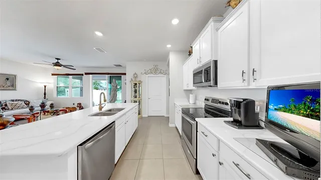 a large kitchen with kitchen island a sink table and chairs