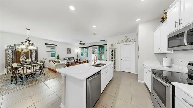 a view of a kitchen with a sink stove and cabinets