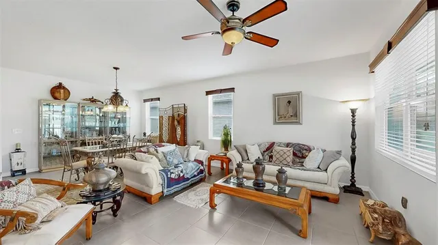 a living room with furniture and chandelier