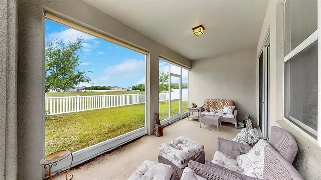 a view of living room with furniture and floor to ceiling window