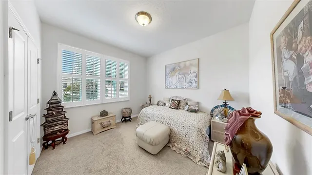 a bedroom with furniture and a large window