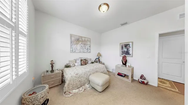 a bedroom with furniture and a window