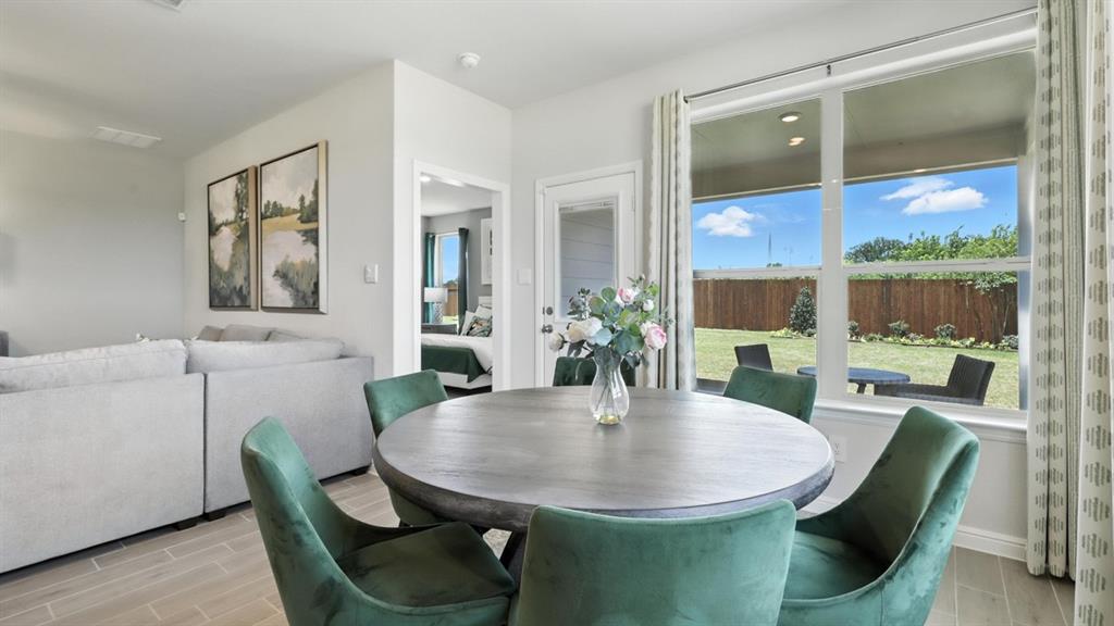 657 Harvey Street Grandview, TX 76050 - Photo 10 of 40 a view of a dining room with furniture and wooden floor