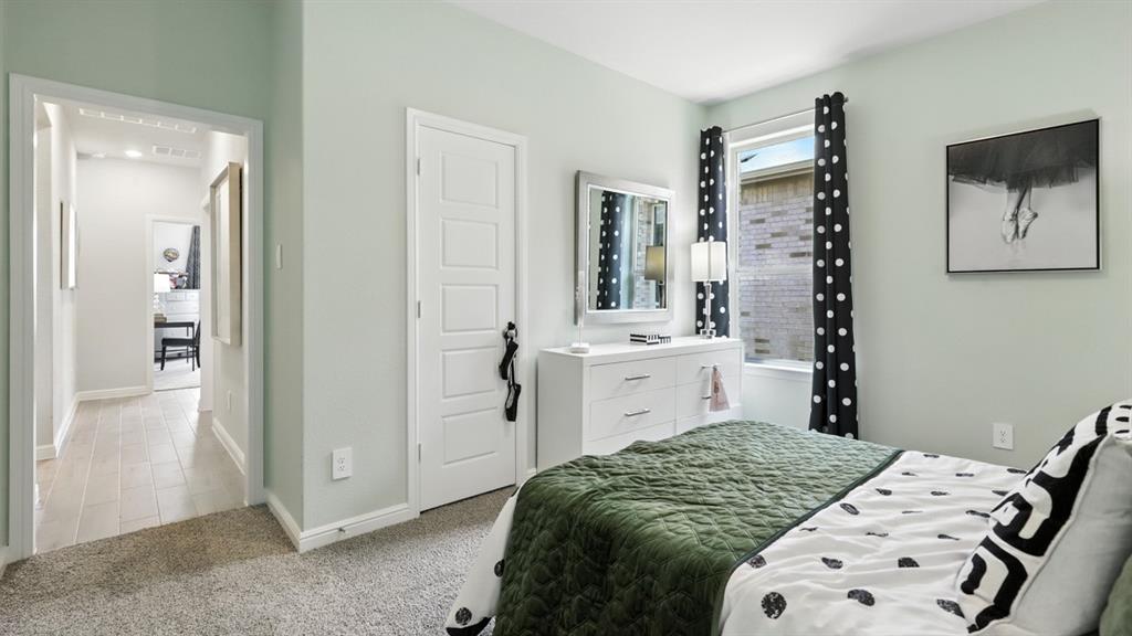 657 Harvey Street Grandview, TX 76050 - Photo 28 of 40 a bedroom with a bed and a mirror