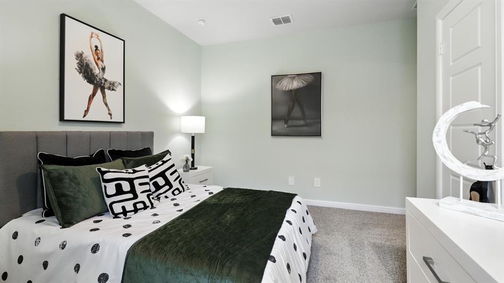 657 Harvey Street Grandview, TX 76050 - Photo 30 of 40 a bedroom with a bed and a lamp on dresser