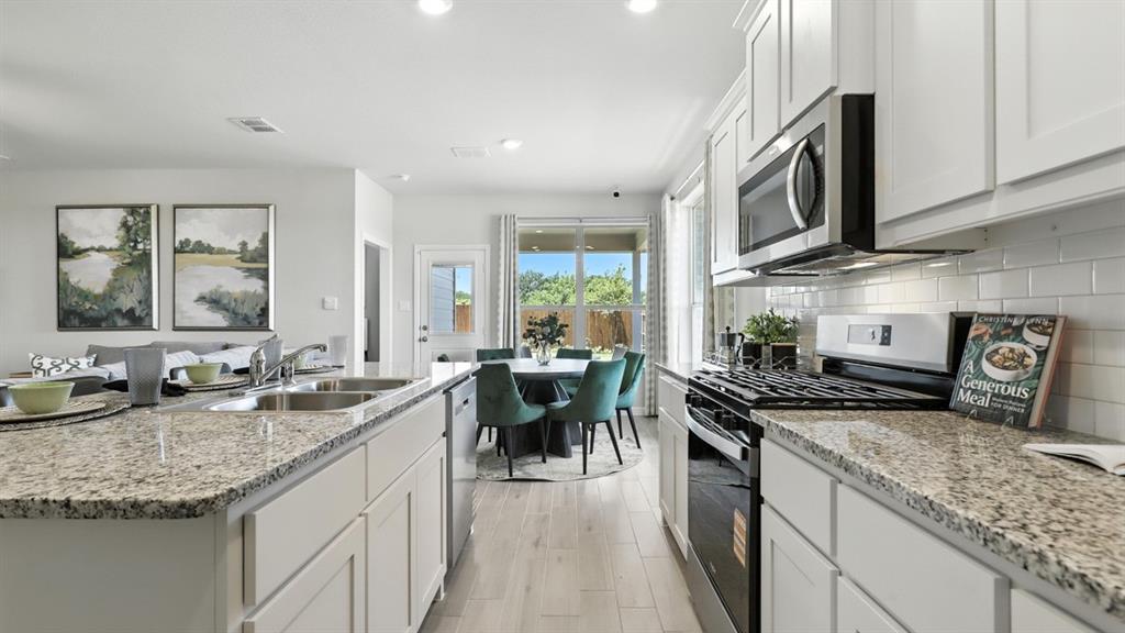 657 Harvey Street Grandview, TX 76050 - Photo 2 of 40 a kitchen with granite countertop lots of counter top space