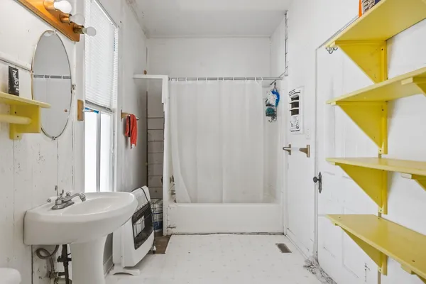 a bathroom with a sink a mirror and a bathtub